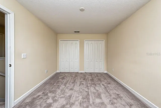 an empty room with closet area