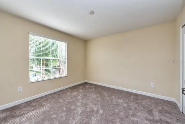 a view of an empty room and a window