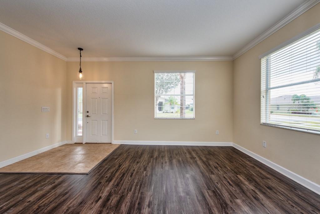 2409 Allegheny Valley Street Ruskin, FL 33570 - Photo 4 of 53 an empty room with wooden floor and windows