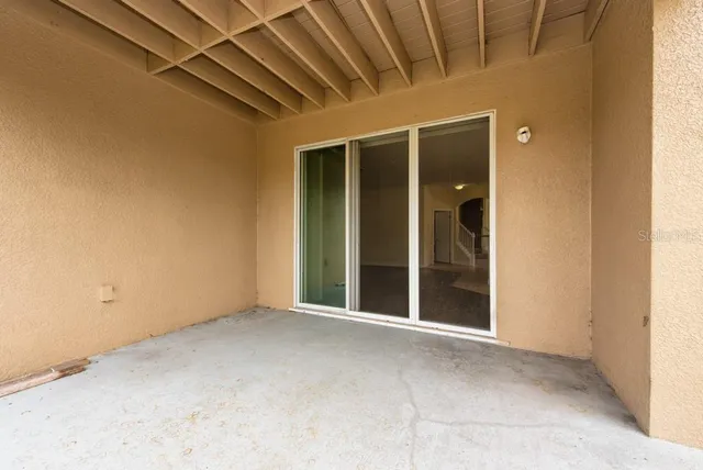 a backyard of a house with a garden and plants