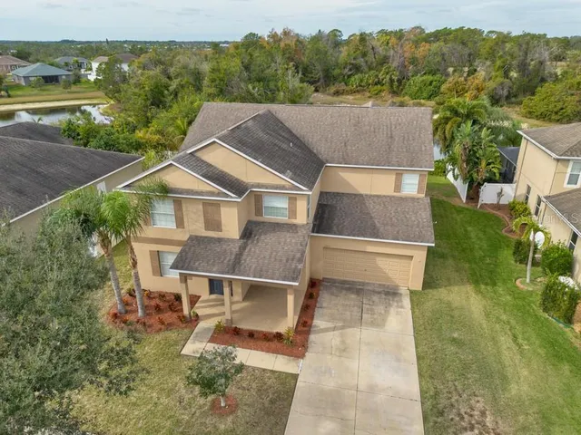 an aerial view of residential houses with outdoor space