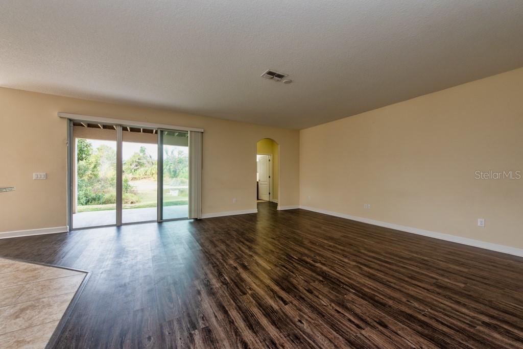 2409 Allegheny Valley Street Ruskin, FL 33570 - Photo 7 of 53 a view of an empty room with wooden floor and a window