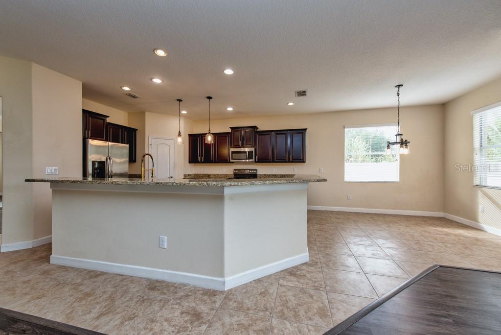 2409 Allegheny Valley Street Ruskin, FL 33570 - Photo 10 of 53 a kitchen with stainless steel appliances granite countertop a refrigerator and a sink