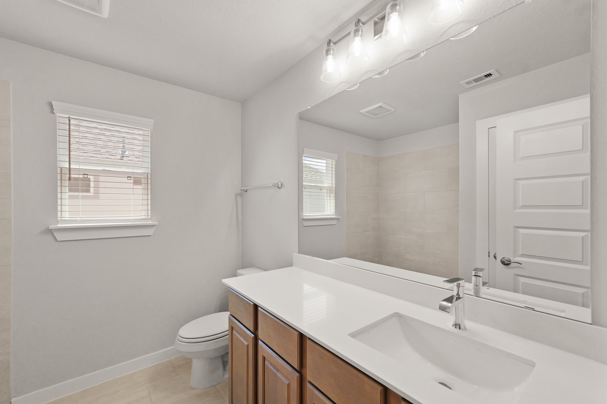 4603 Whisperwood Drive Rosenberg, TX 77471 - Photo 36 of 50 a bathroom with a sink a toilet and a mirror