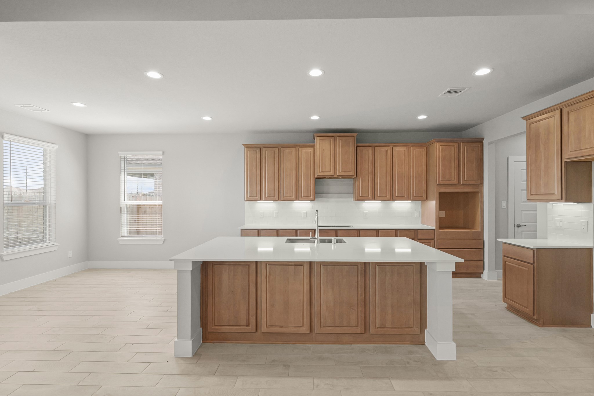 4603 Whisperwood Drive Rosenberg, TX 77471 - Photo 4 of 50 a kitchen with stainless steel appliances granite countertop a stove a sink a refrigerator white cabinets and a refrigerator