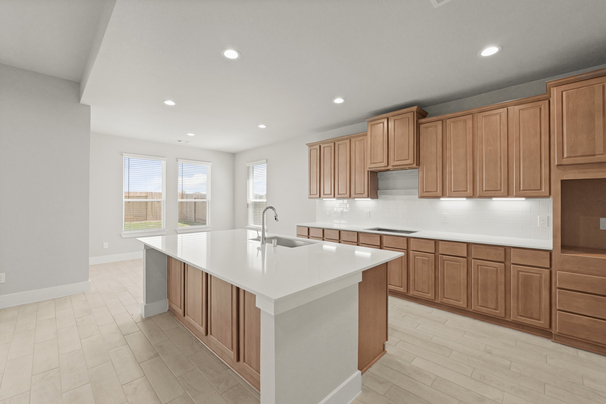4603 Whisperwood Drive Rosenberg, TX 77471 - Photo 5 of 50 a kitchen with kitchen island granite countertop a sink and white cabinets