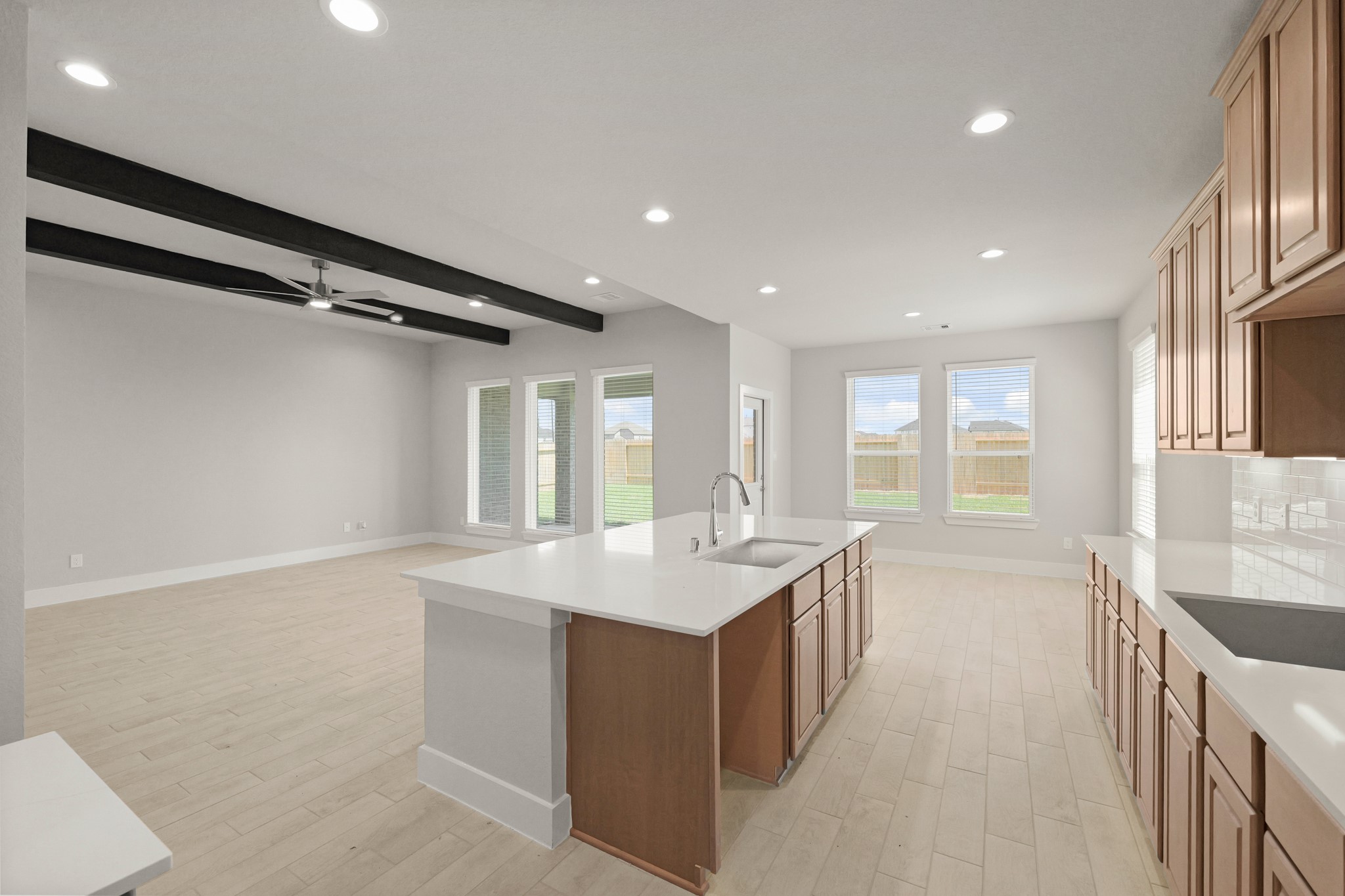 4603 Whisperwood Drive Rosenberg, TX 77471 - Photo 9 of 50 a large kitchen with kitchen island a large island a sink stainless steel appliances and cabinets