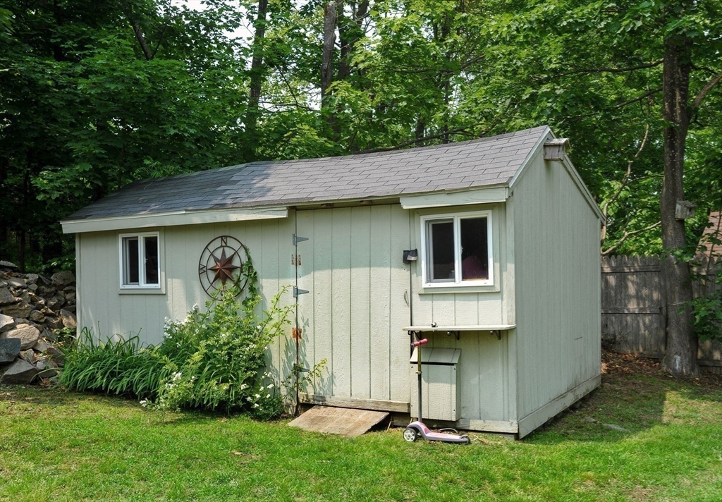 198 Hull Street Hingham, MA 02043 - Photo 15 of 15 a front view of a house with a garden