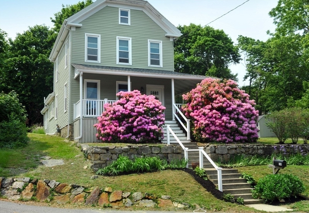 198 Hull Street Hingham, MA 02043 - Photo 2 of 15 a front view of a house with a yard and garage