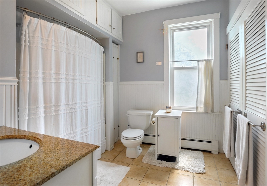 198 Hull Street Hingham, MA 02043 - Photo 6 of 15 a bathroom with a granite countertop sink and a mirror