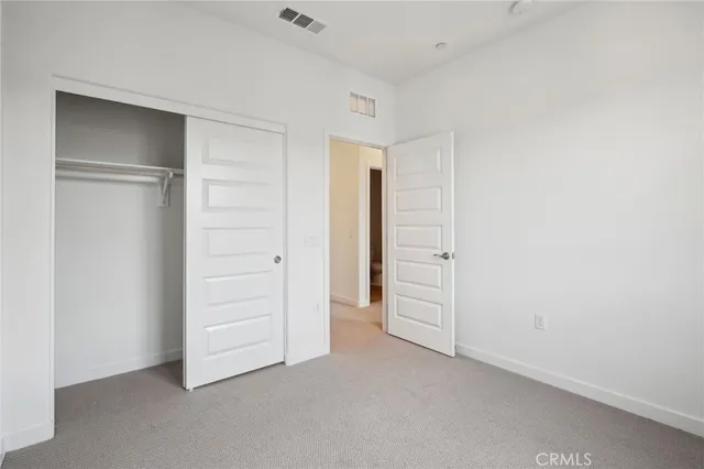 an empty room with closet area
