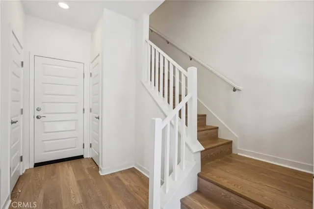 a view of entryway with wooden floor and stairs