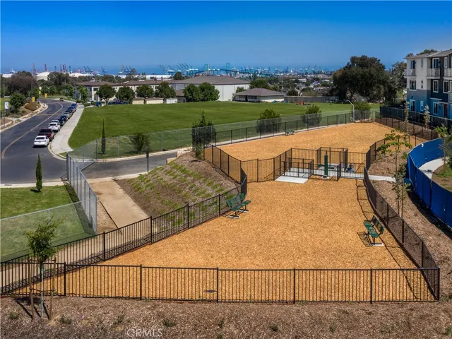 a view of a patio with couches table and chairs and potted plants