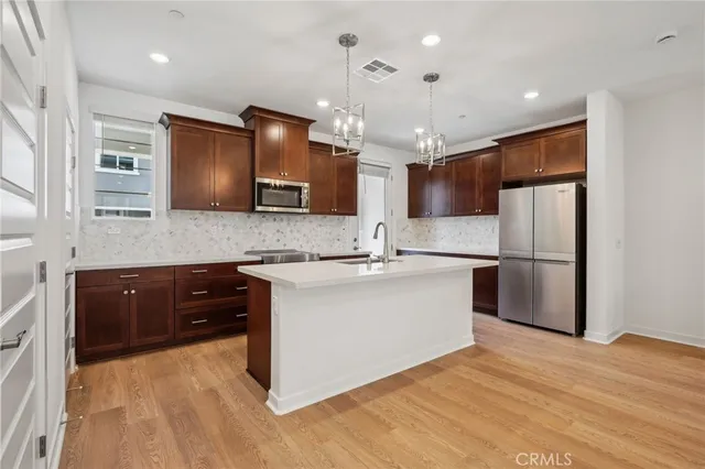 a large kitchen with a large counter top appliances and cabinets