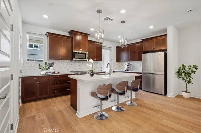 a kitchen with kitchen island a counter top space appliances and cabinets
