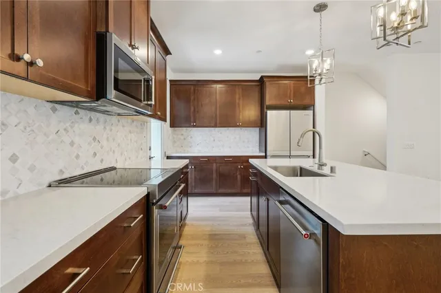 a kitchen with a sink and a refrigerator