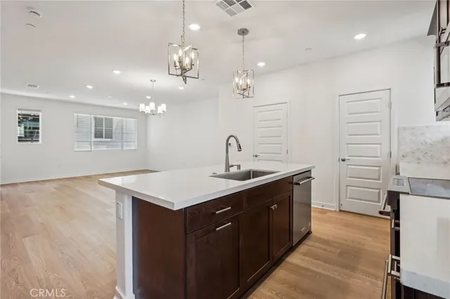 a kitchen with kitchen island a sink stainless steel appliances and cabinets