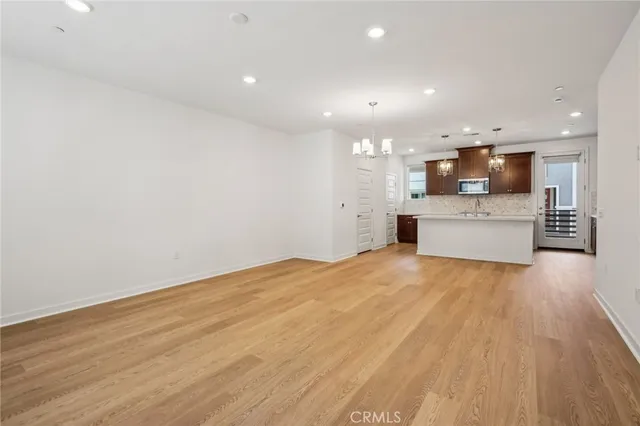 a view of kitchen with cabinets and wooden floor