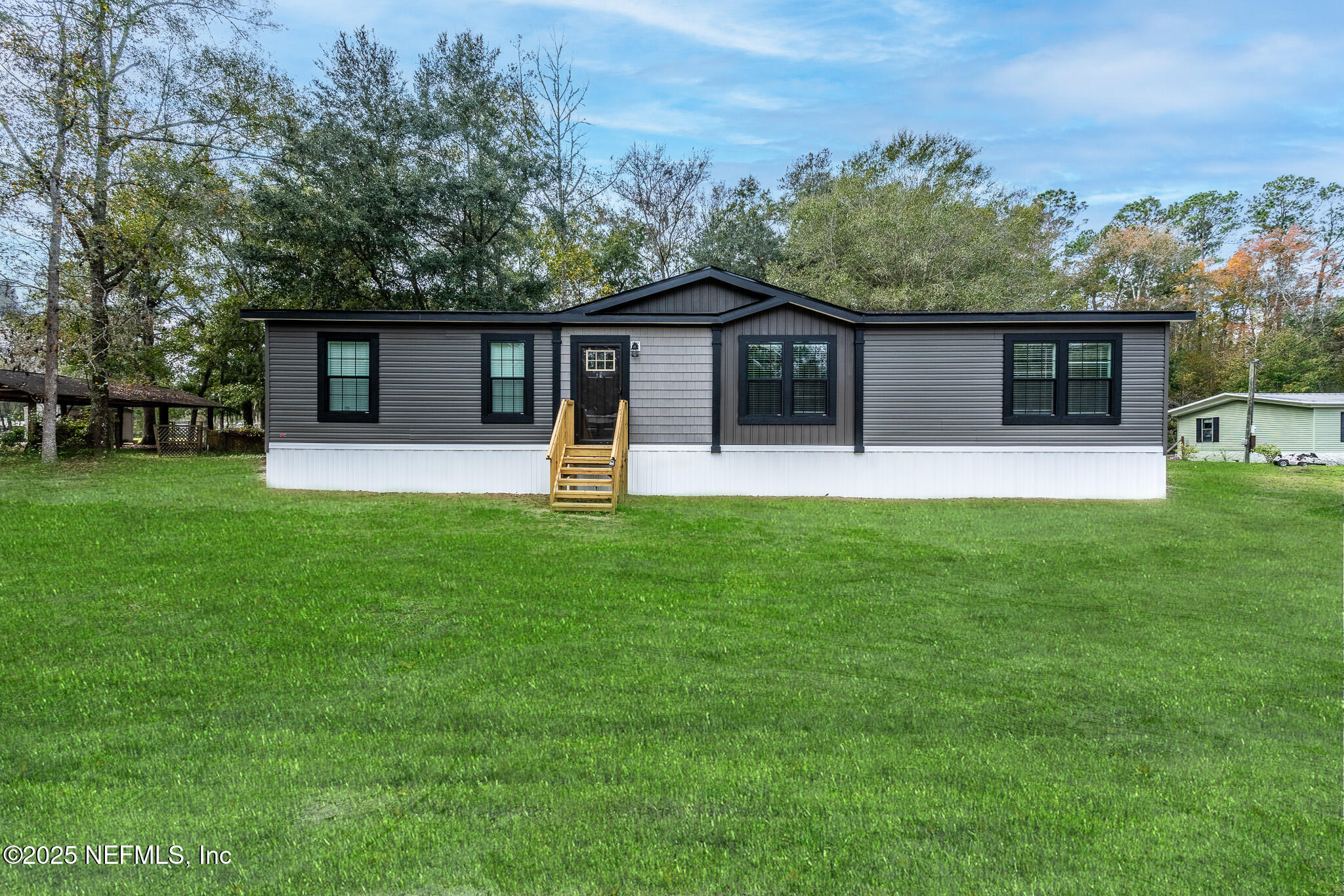 a front view of house with yard and green space