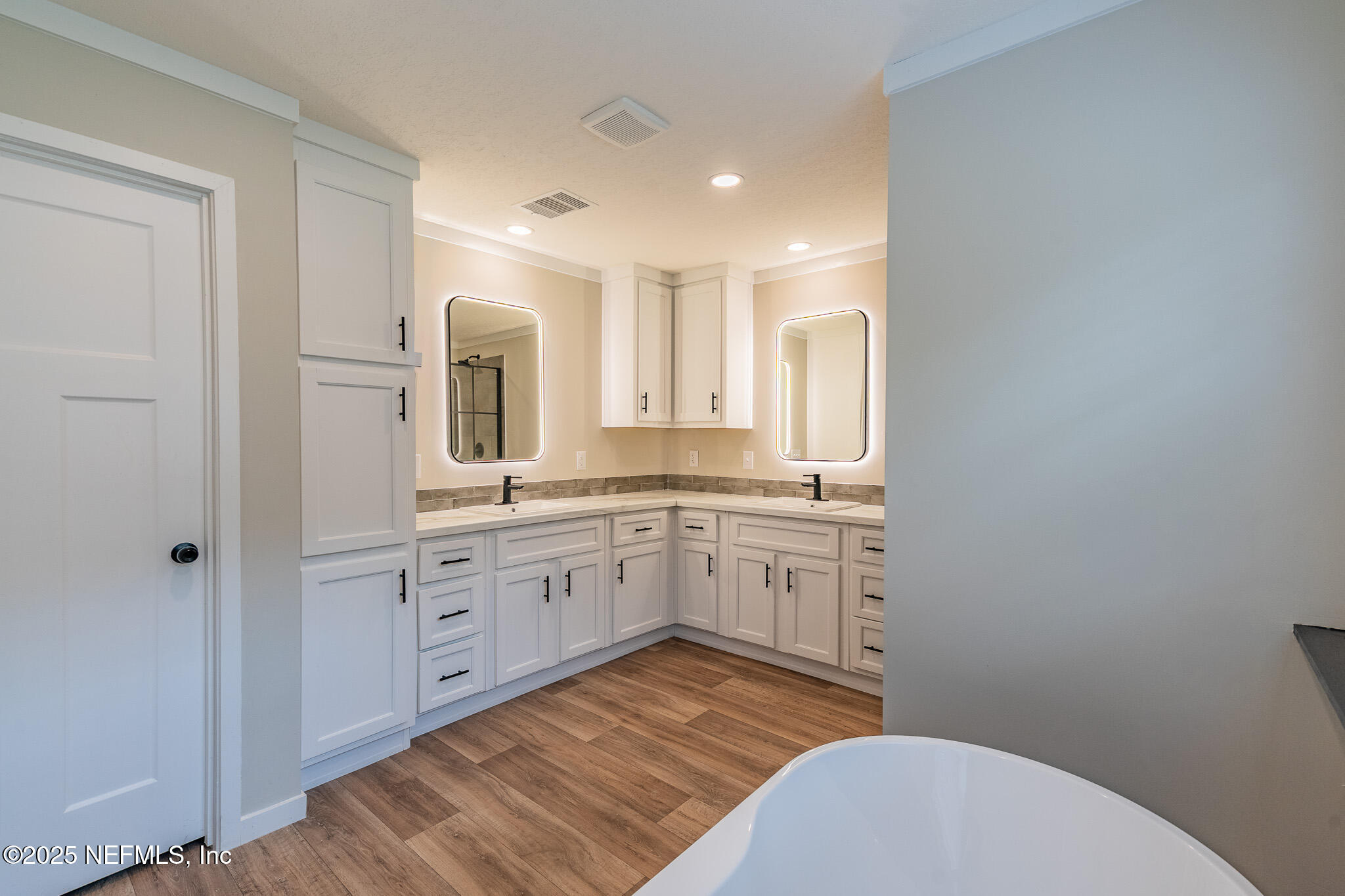 54405 Lee Stoner Road East Callahan, FL 32011 - Photo 12 of 24 a spacious bathroom with a granite countertop sink mirror and toilet