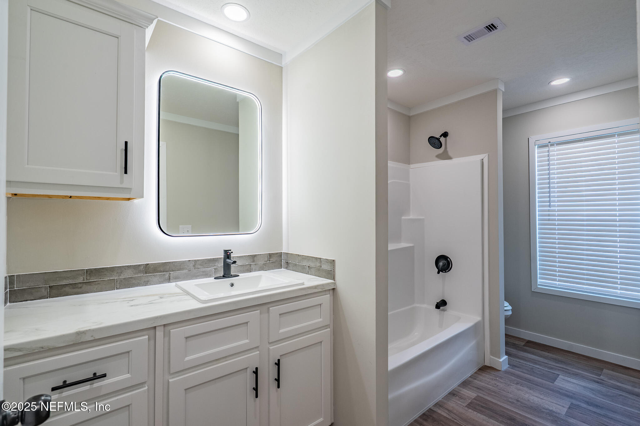 54405 Lee Stoner Road East Callahan, FL 32011 - Photo 17 of 24 a bathroom with a tub sink and mirror