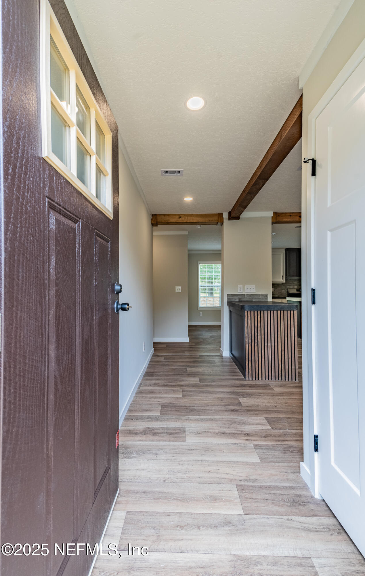 54405 Lee Stoner Road East Callahan, FL 32011 - Photo 2 of 24 a view of a hallway with wooden floor and stairs