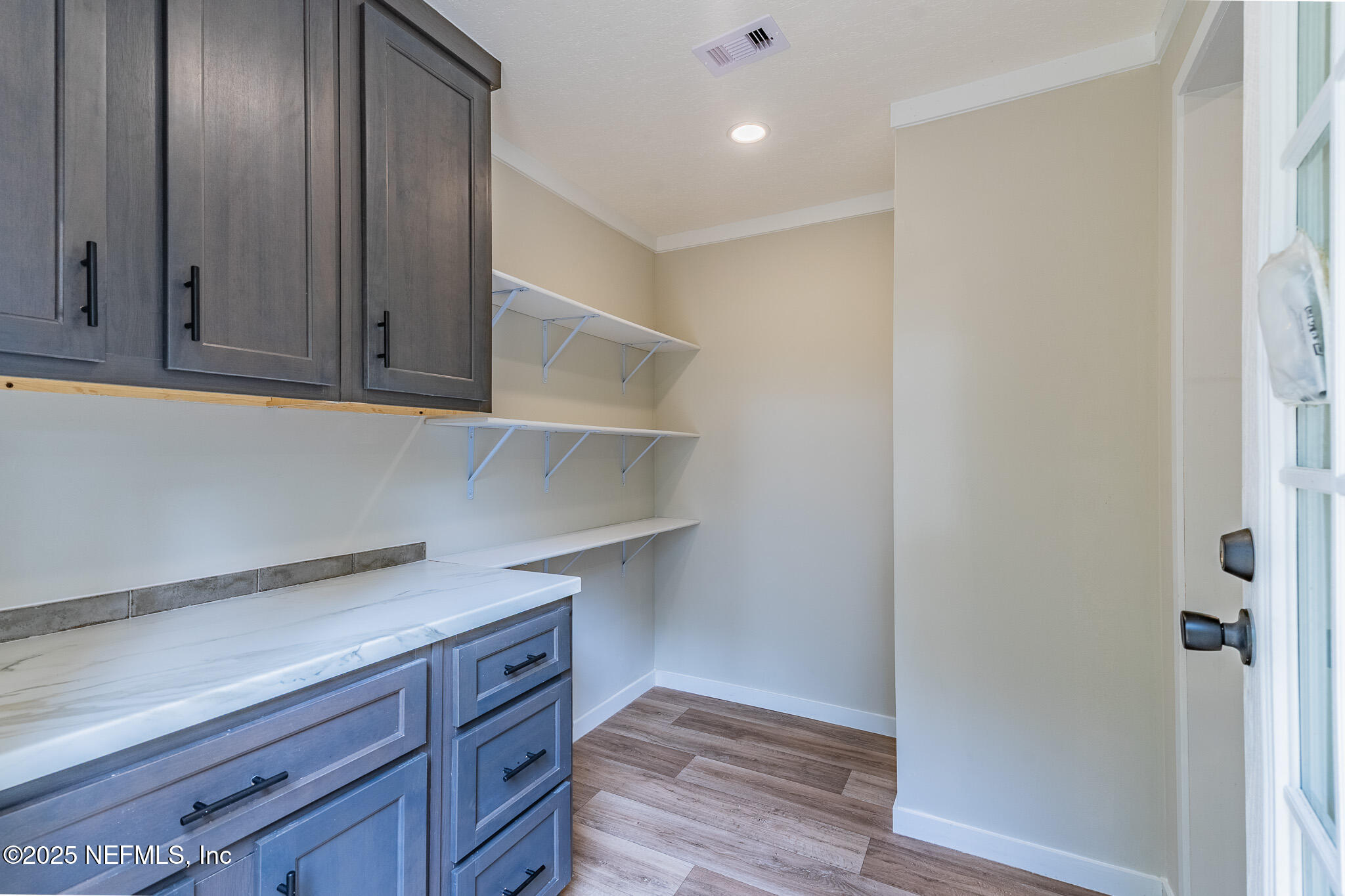 54405 Lee Stoner Road East Callahan, FL 32011 - Photo 23 of 24 a view of cabinets with wooden floor