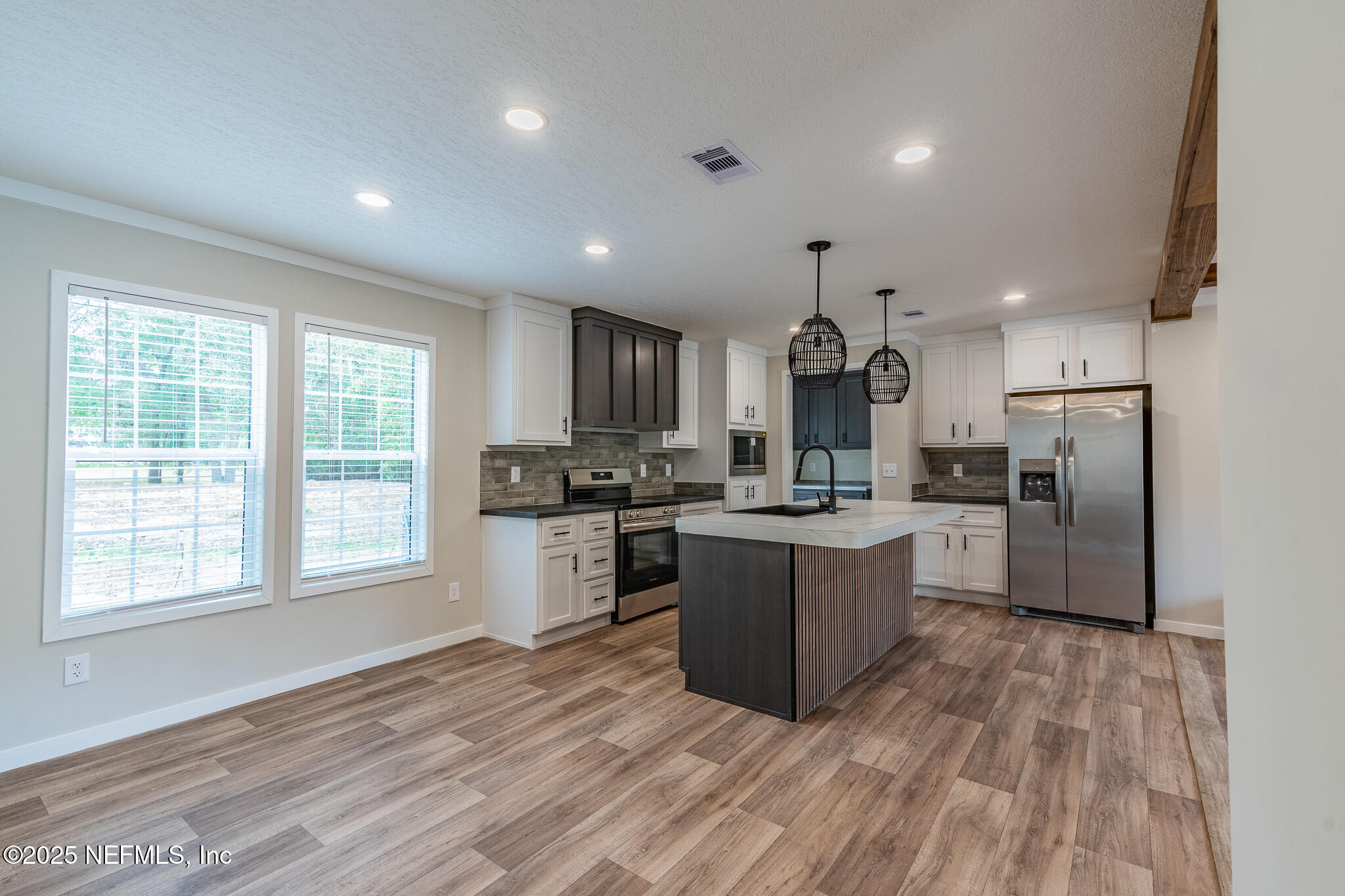 54405 Lee Stoner Road East Callahan, FL 32011 - Photo 6 of 24 a kitchen with a refrigerator and a stove top oven