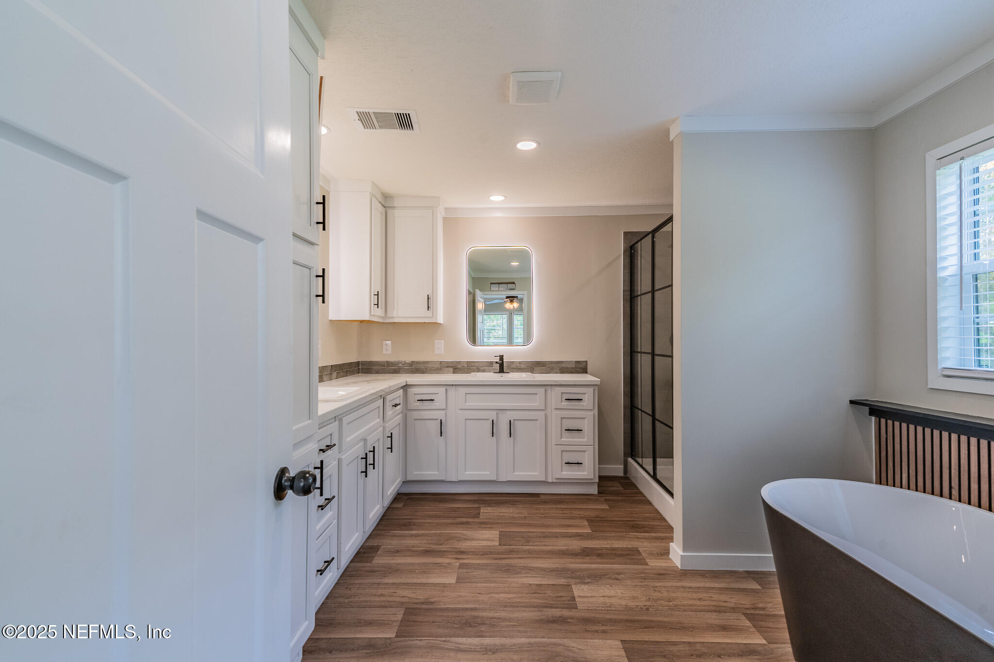 54405 Lee Stoner Road East Callahan, FL 32011 - Photo 10 of 24 a spacious bathroom with a granite countertop sink and a mirror