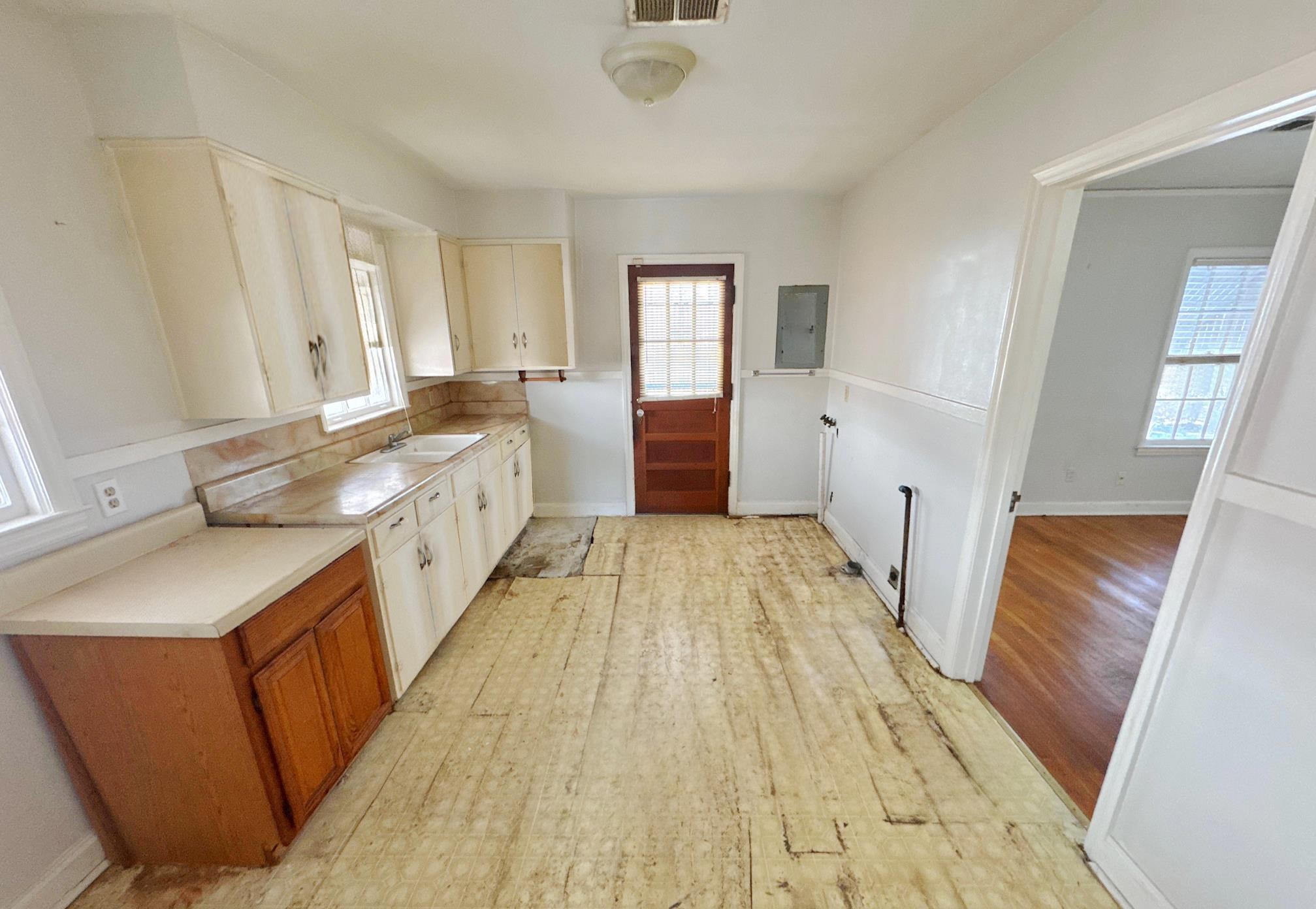 1454 Railton Road Memphis, TN 38111 - Photo 4 of 10 a large kitchen with a sink and wooden floor