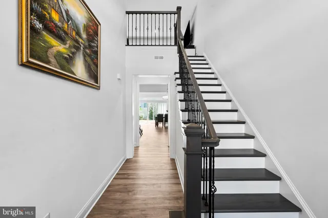 a view of a hallway with wooden floor and entryway