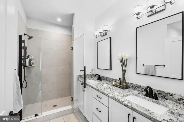 a kitchen with granite countertop a sink a center island stainless steel appliances and cabinets