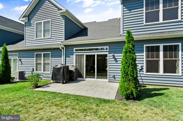a front view of a house with a yard and outdoor seating