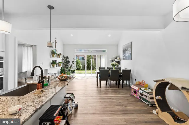 a very nice looking living room with dining room and wooden floor