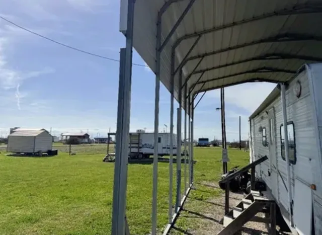 a view of a chair and tables in the patio with a yard