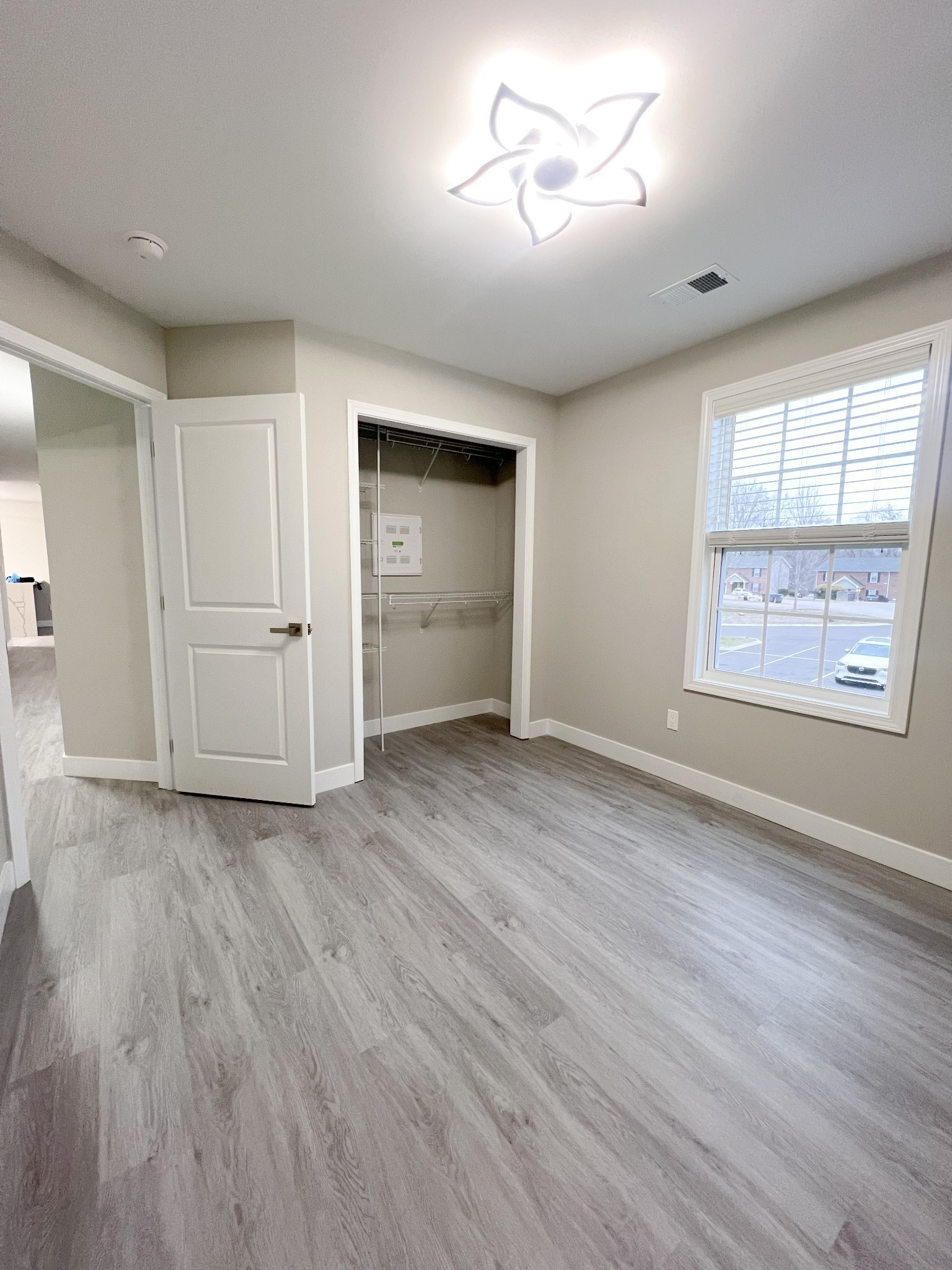 543 Peachers Mill Road, Unit 213 Clarksville, TN 37042 - Photo 12 of 21 an empty room with wooden floor chandelier and windows