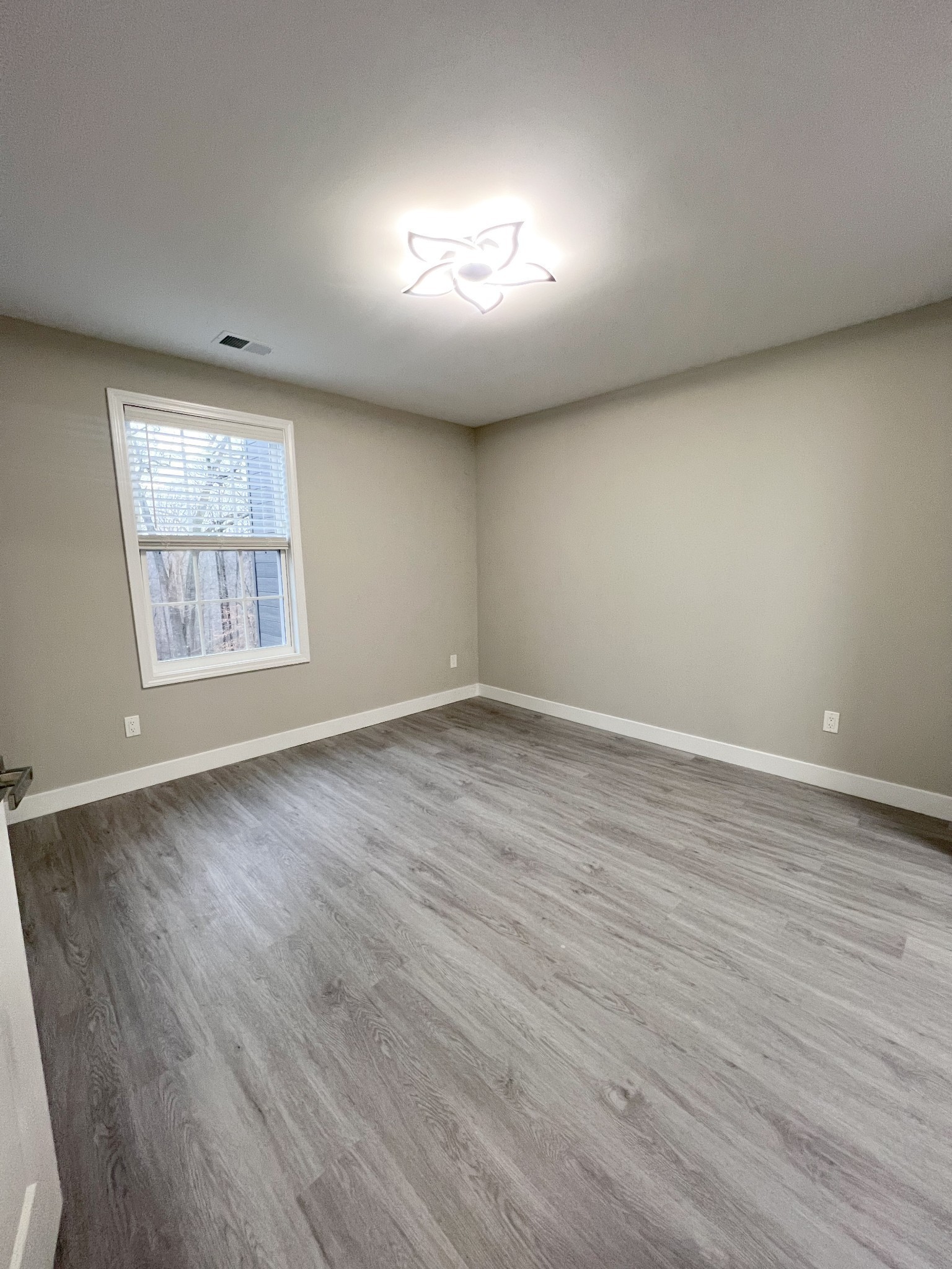 543 Peachers Mill Road, Unit 213 Clarksville, TN 37042 - Photo 14 of 21 an empty room with wooden floor and windows