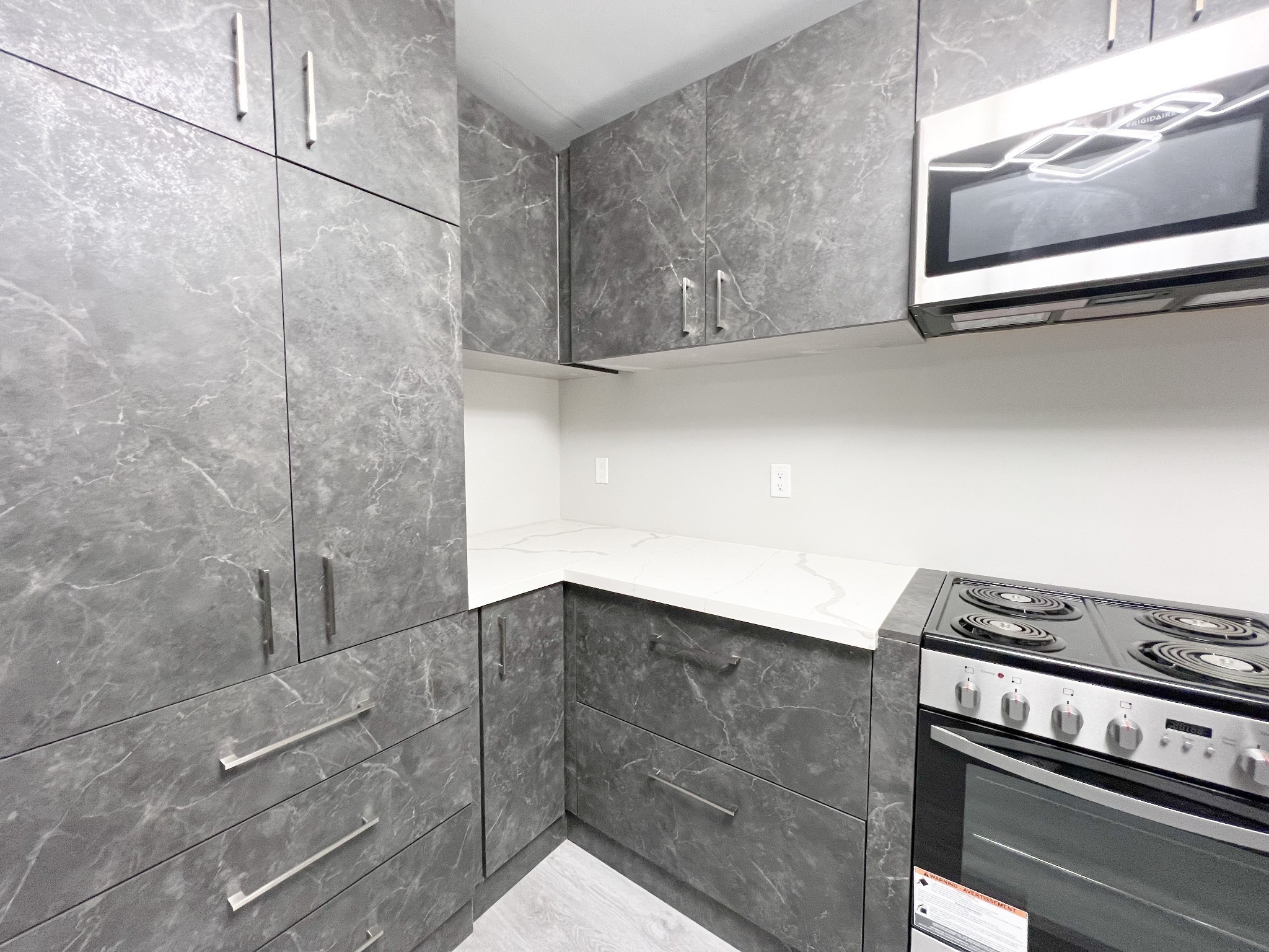 543 Peachers Mill Road, Unit 213 Clarksville, TN 37042 - Photo 6 of 21 a kitchen with a stove and a microwave