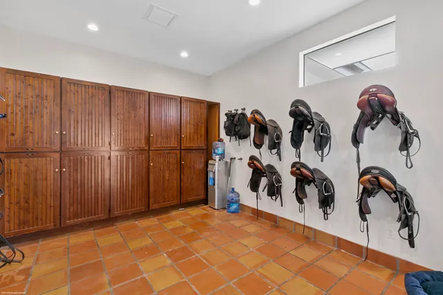 a view of staircase with railing and white walls
