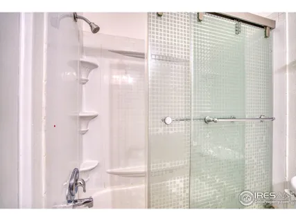 a bedroom with a large bed and a large window