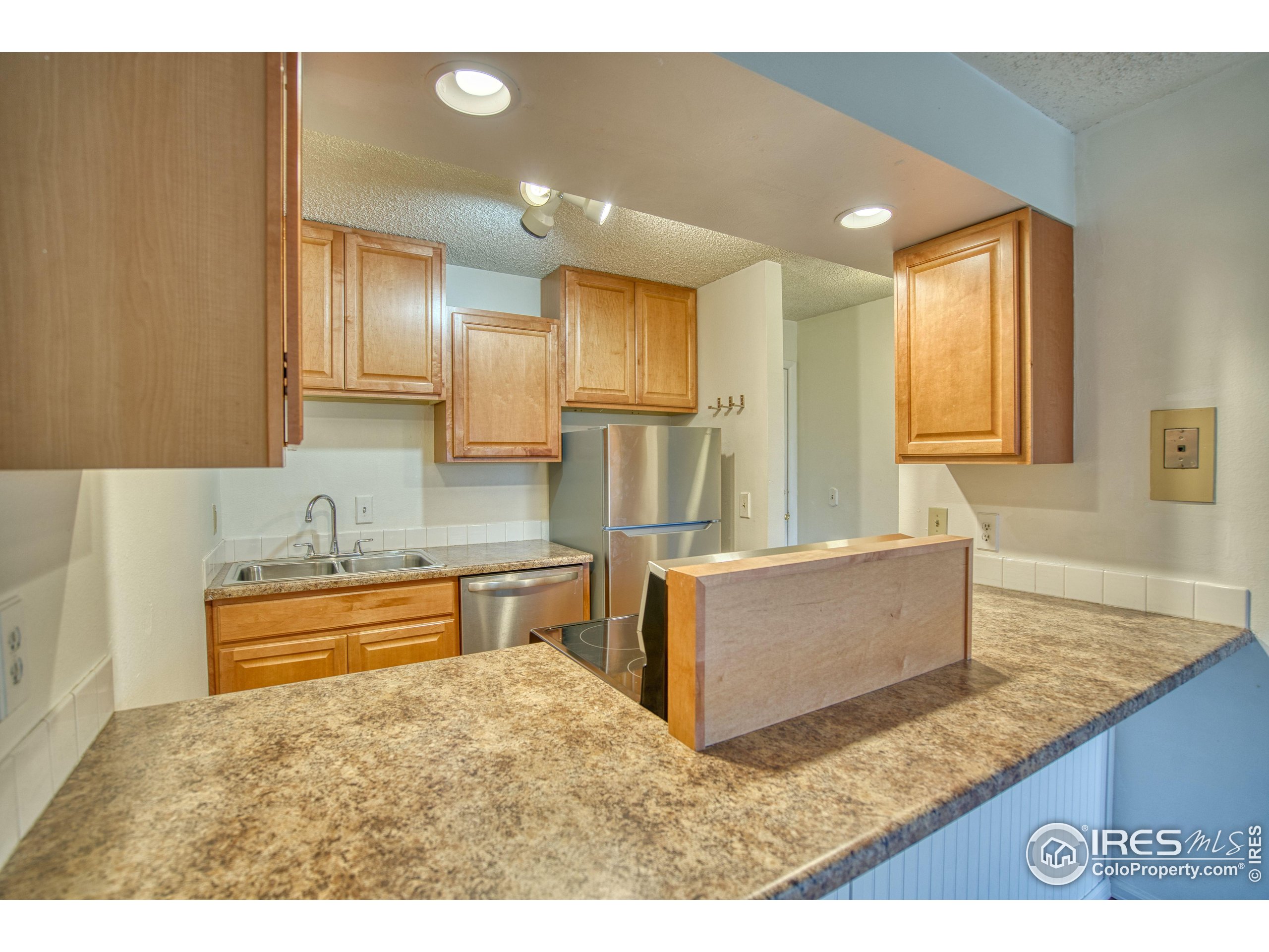 2707 Valmont Road, Unit 304 Boulder, CO 80304 - Photo 2 of 18 a kitchen with stainless steel appliances granite countertop a sink and a refrigerator