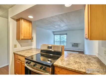 a kitchen with a sink cabinets and wooden floor