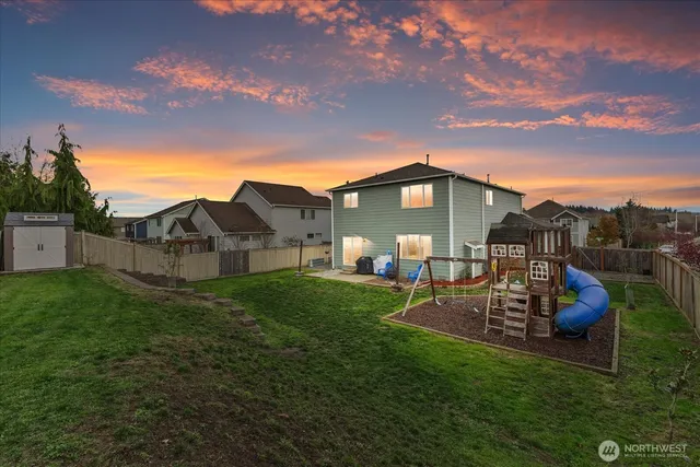 a backyard of a house with table and chairs