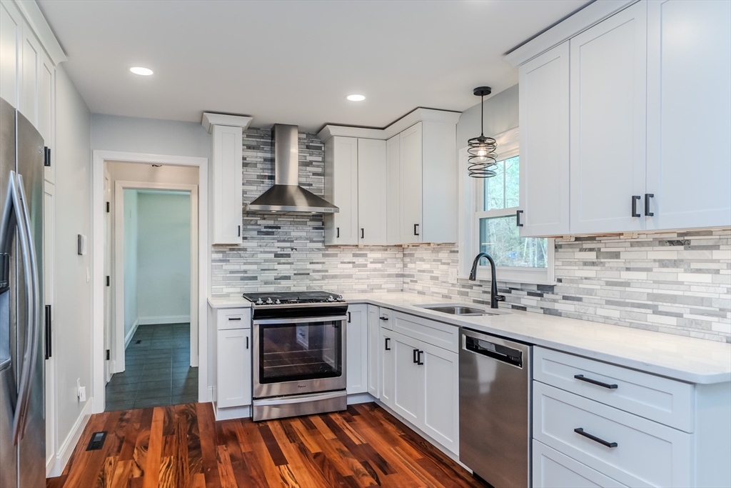 21 Shattuck Road Hadley, MA 01035 - Photo 23 of 42 a kitchen with stainless steel appliances granite countertop a sink and stove top oven