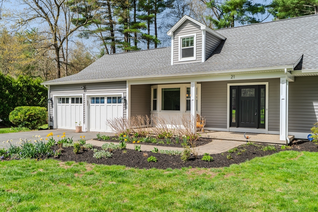 21 Shattuck Road Hadley, MA 01035 - Photo 3 of 42 a front view of a house with a yard and potted plants