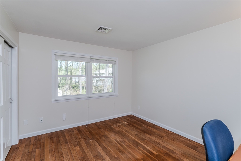 21 Shattuck Road Hadley, MA 01035 - Photo 38 of 42 an empty room with wooden floor and windows