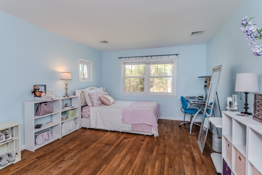 21 Shattuck Road Hadley, MA 01035 - Photo 40 of 42 a bedroom with a bed and a wooden floor