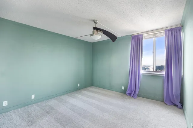 a bathroom with a granite countertop sink toilet a mirror and shower