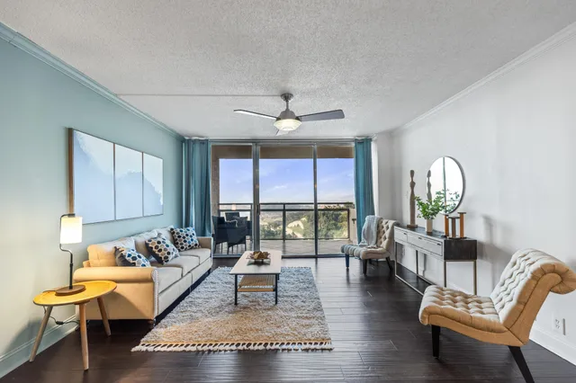 a living room with furniture and a large window