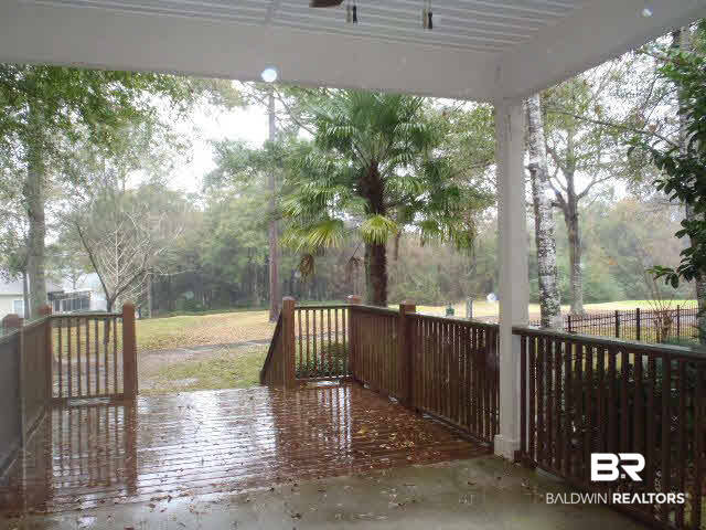 107 Chestnut Ridge Fairhope, AL 36532 - Photo 17 of 20 Covered back porch for grilling and dining with open deck for enjoying the tree shaded back yard and golf course view.